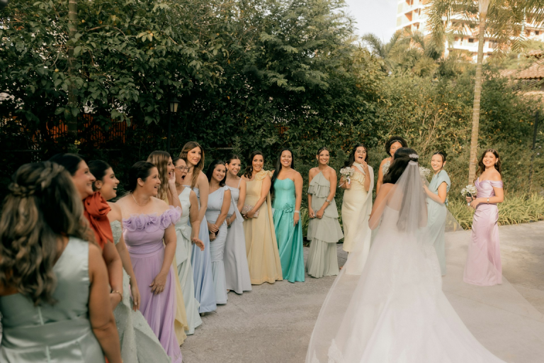 The wedding party members are all lined up as the photographer arrives
