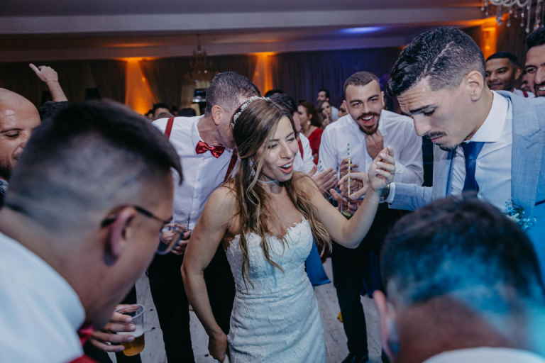 Bride and groom dancing with the guests invited