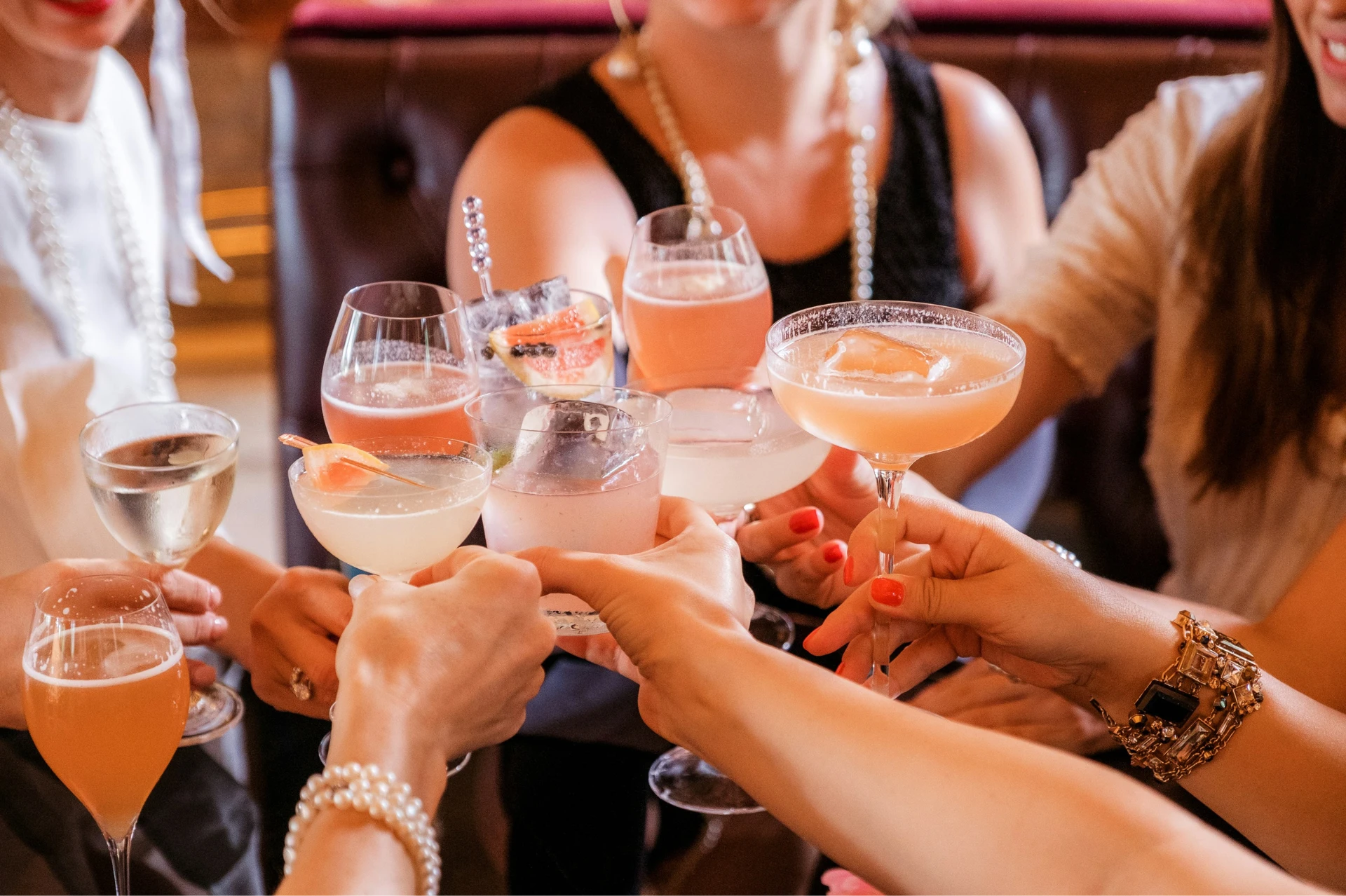 a group of people clinking their cocktails
