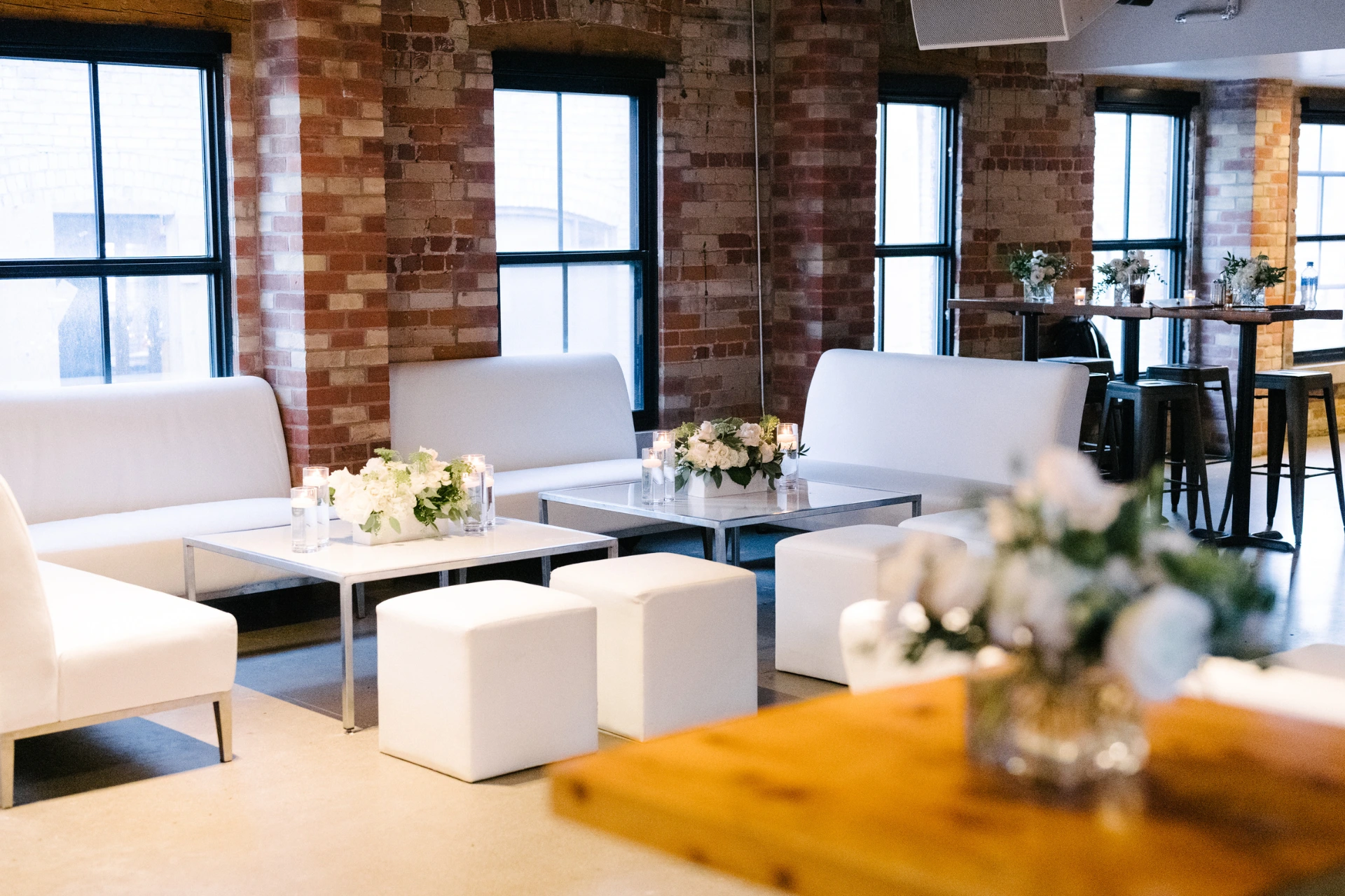 White furniture set up inside The Loft on King for a wedding