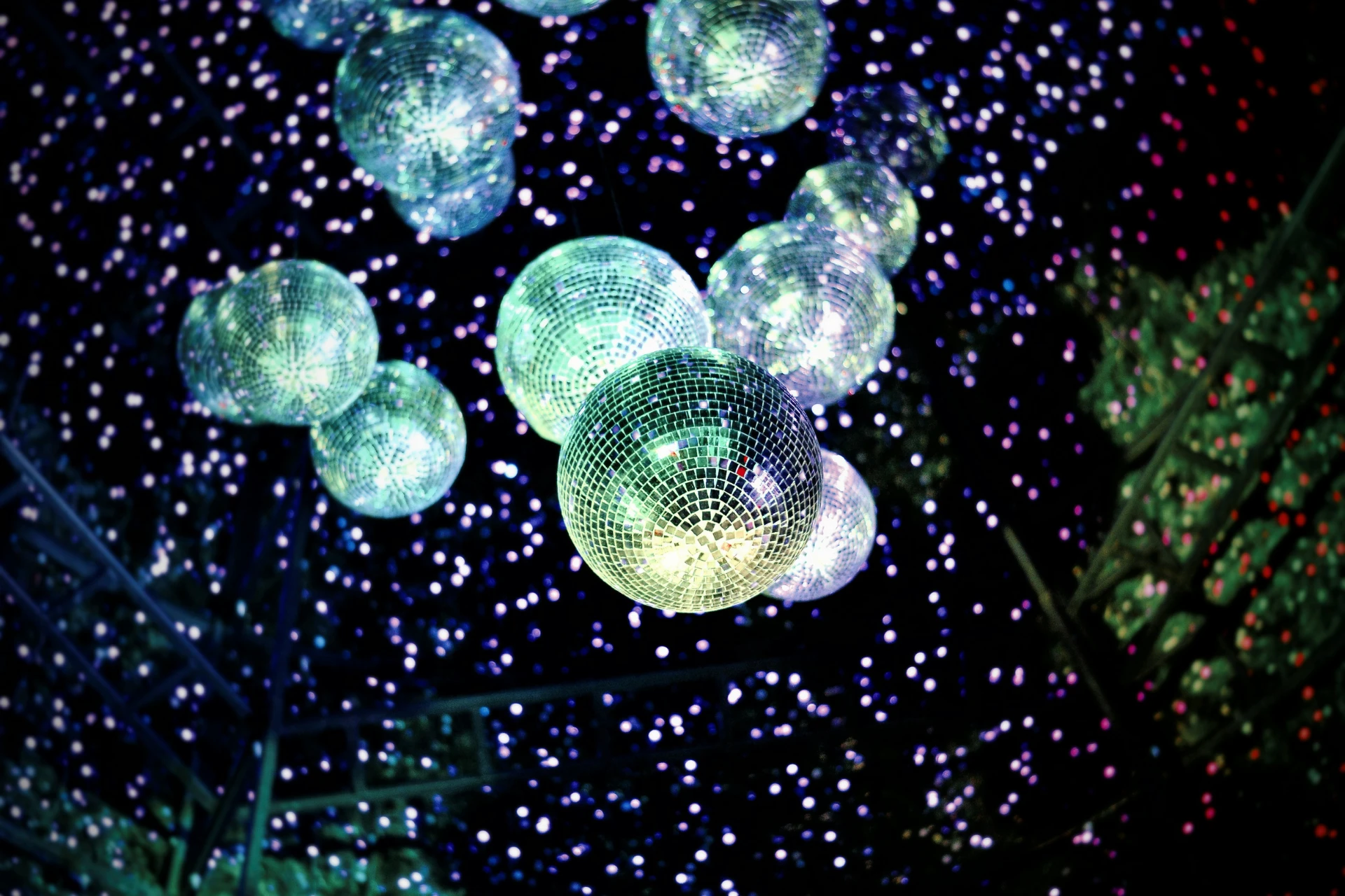 disco balls hanging in a dark room