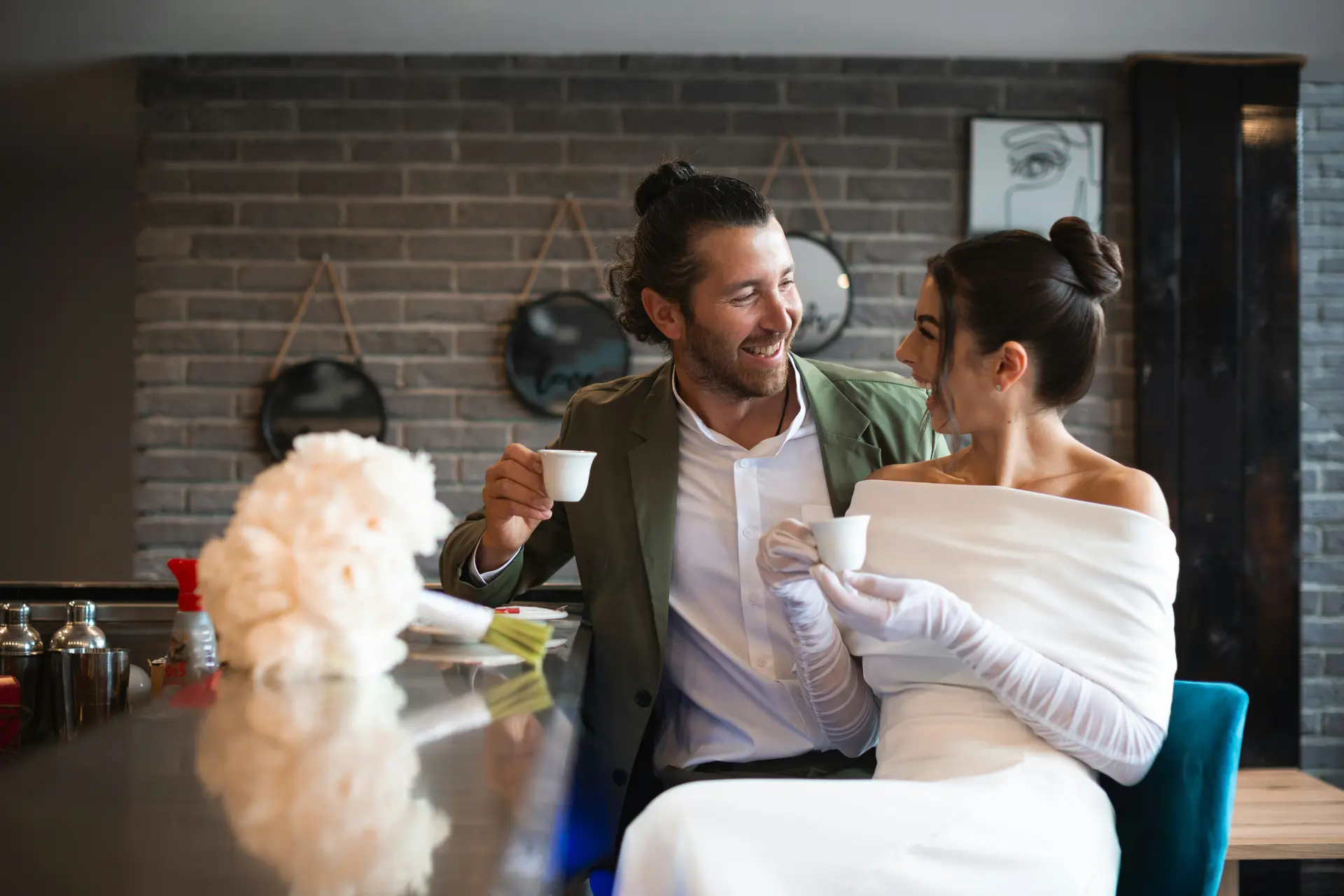 Newlywed couple drinking coffee in a coffee shop 