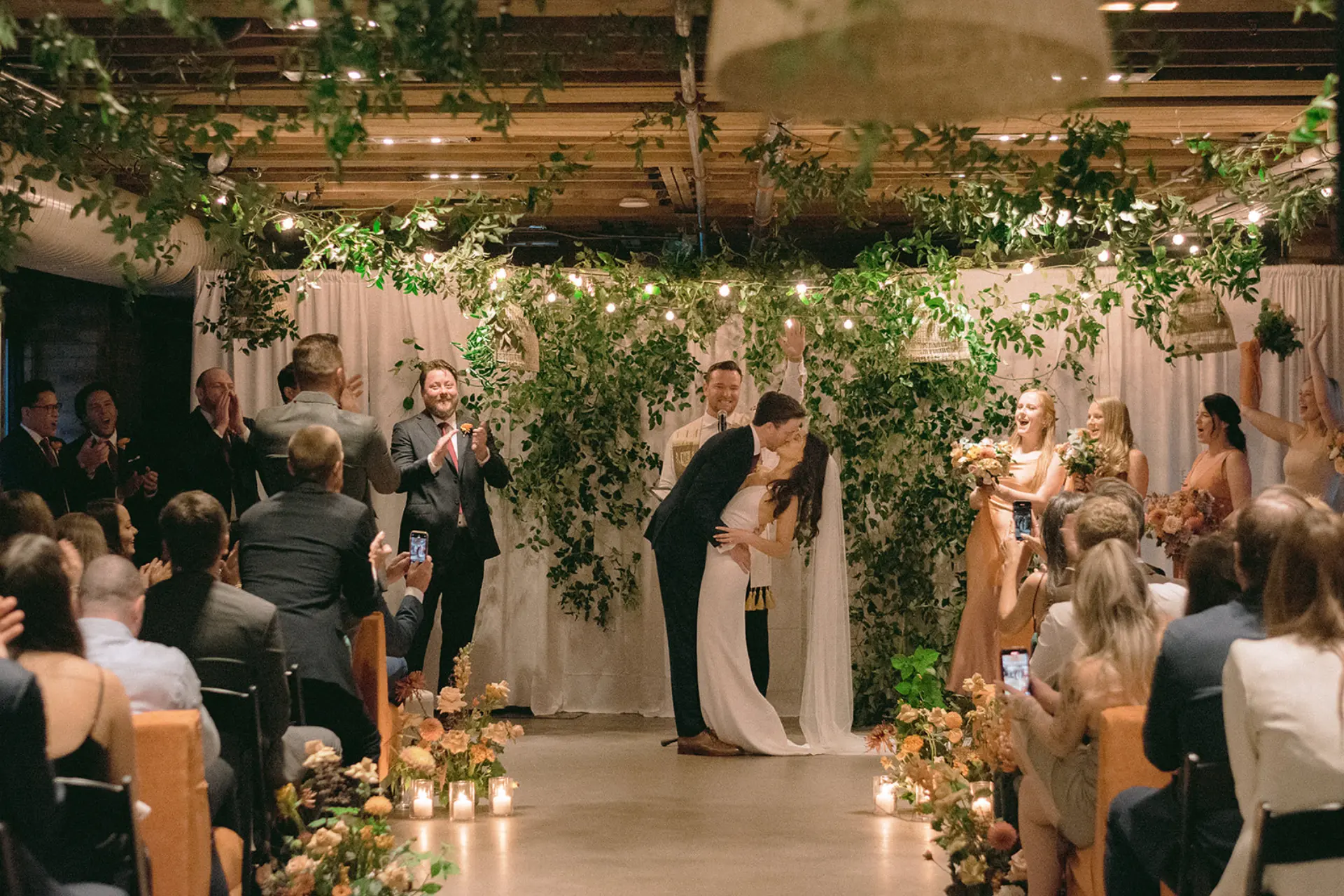 Newlywed couple kissing during their wedding ceremony at The Loft on King