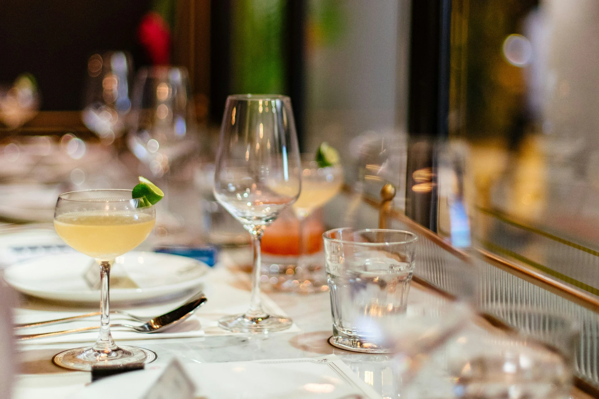 Wine glasses and place settings on a white table