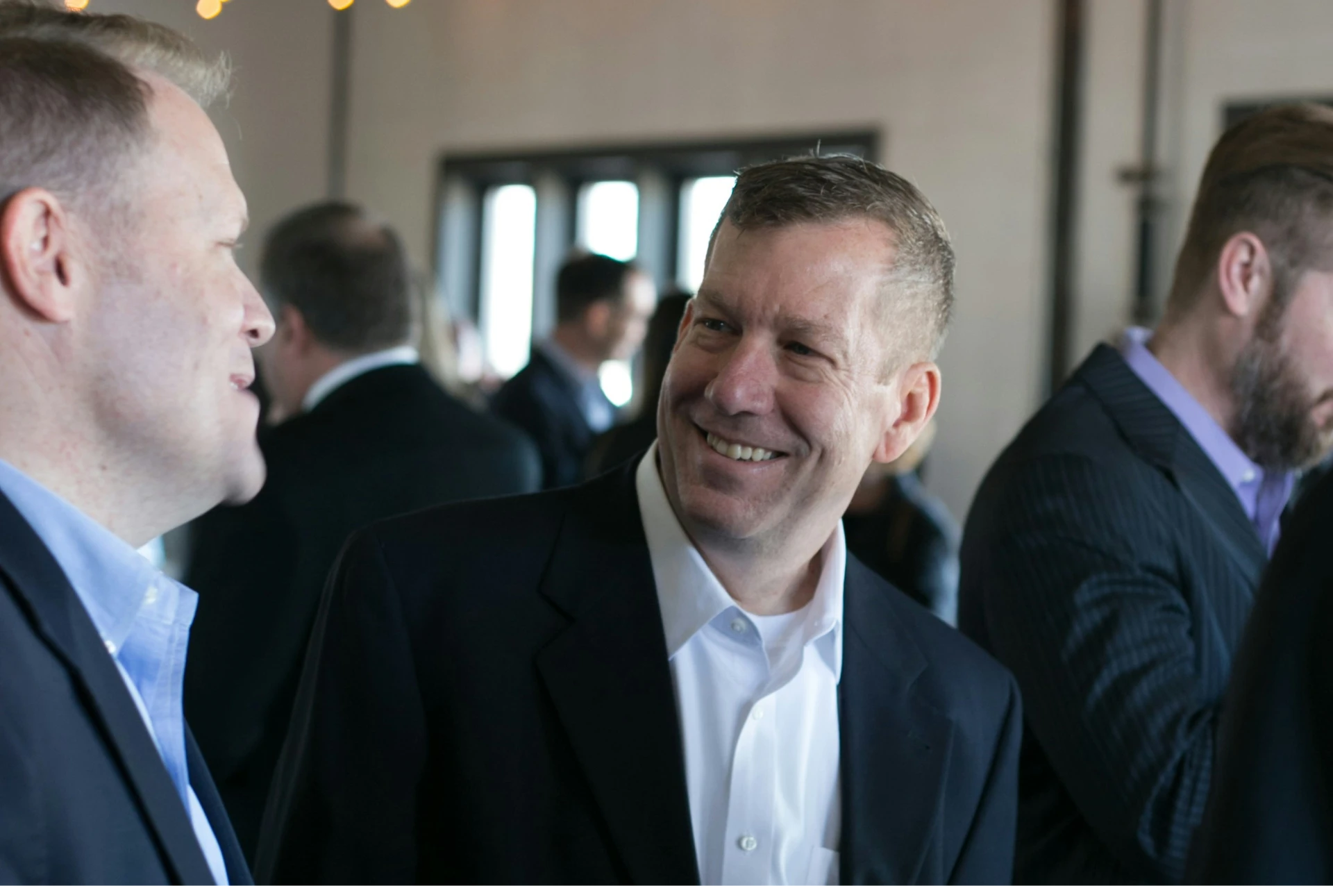 A group of men in suits talking