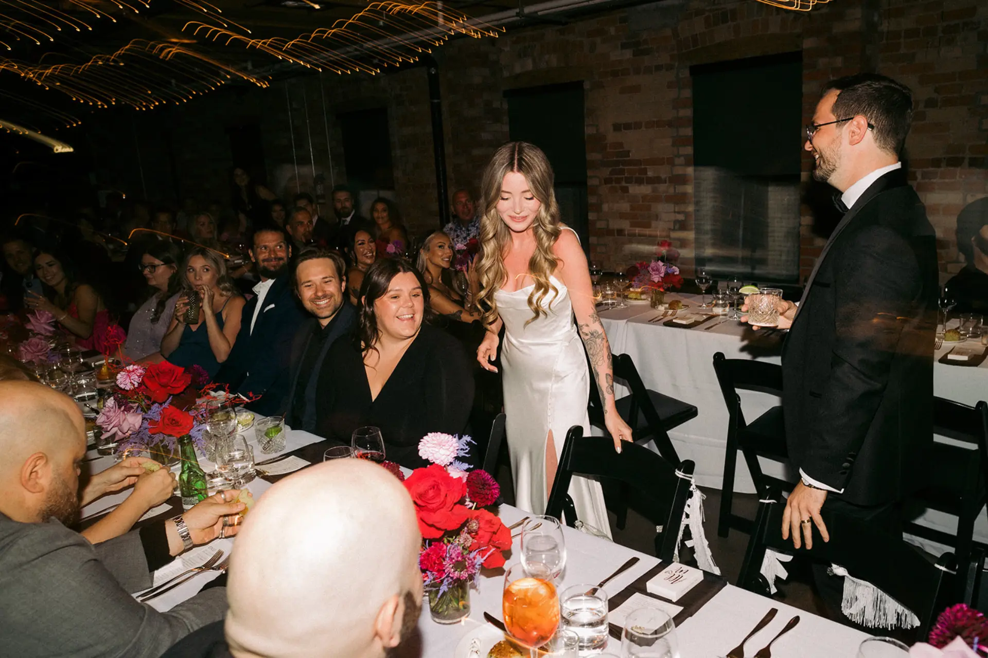 Bride and groom with guests at a wedding in The Loft on King