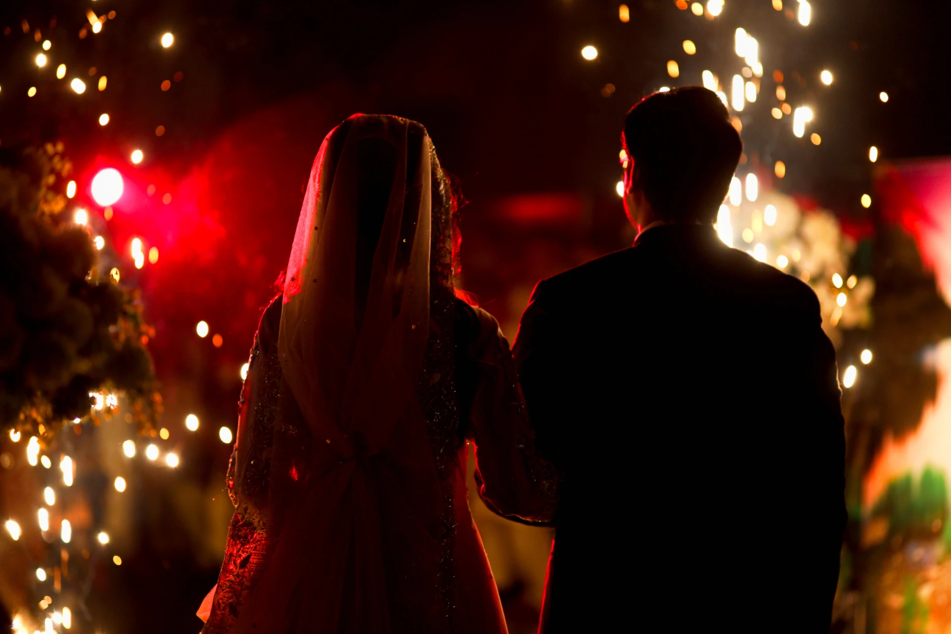 bride and groom walking into their reception party
