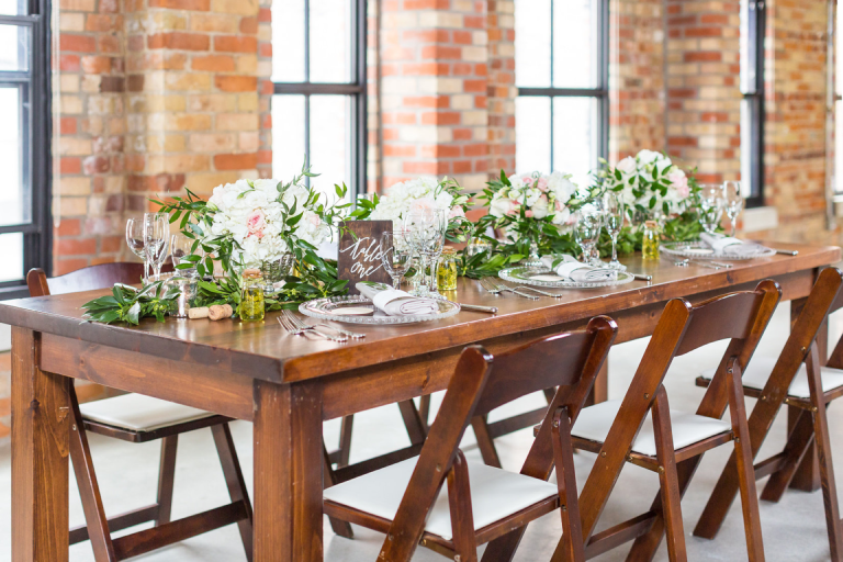 A rectangular table wedding set up with floral centrepieces